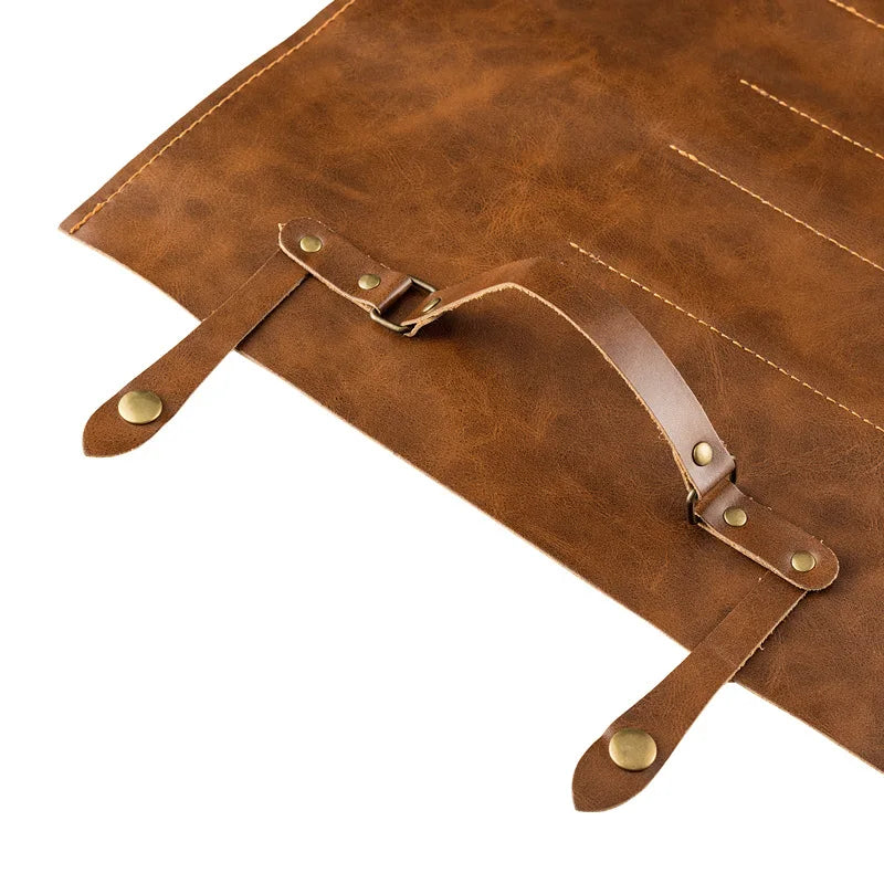Brown leather knife roll with brass buckles and stitching for kitchen knife storage