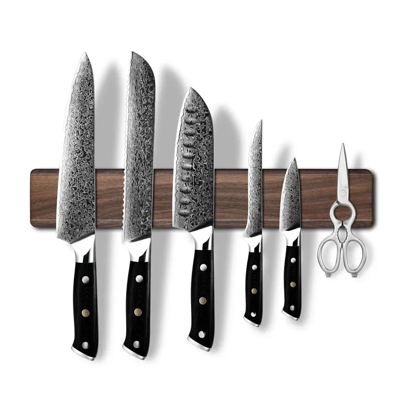 Damascus steel kitchen knives with black handles on magnetic strip, plus kitchen shears
