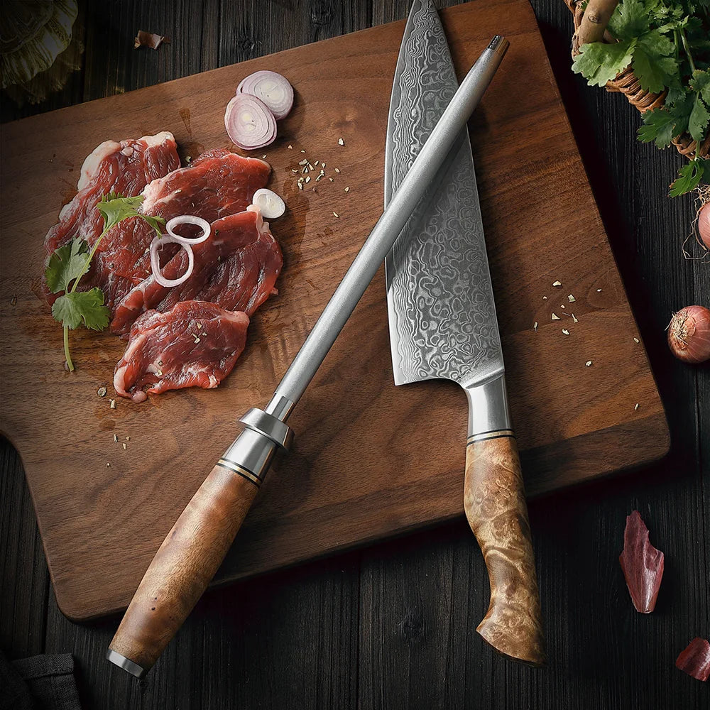 Damascus chef knife and honing steel on wooden cutting board with raw meat and shallots