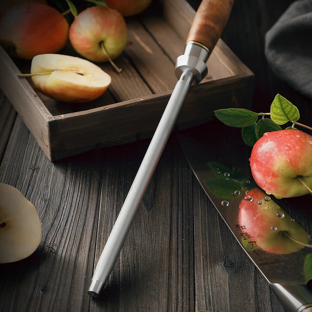 Precision kitchen knife sharpener with wooden handle, next to sliced apples and a chef's knife on rustic wood.
